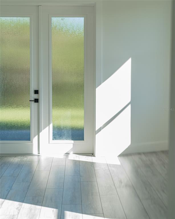 210 Tournament Road Rotonda West, FL 33947 - Photo 16 of 59 a view of a hallway with wooden floor