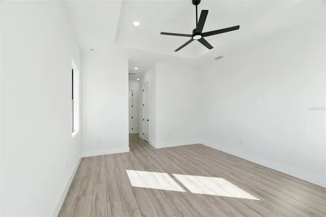 a view of a room with wooden floor and white walls