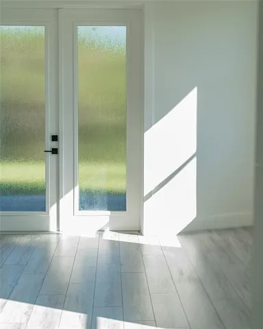 a view of a hallway with wooden floor