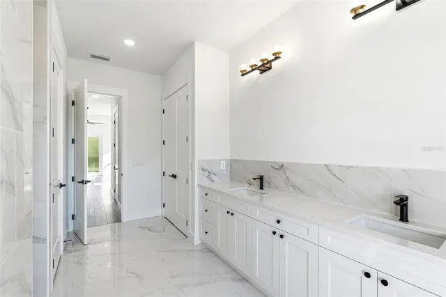 a bathroom with a double vanity sink and mirror