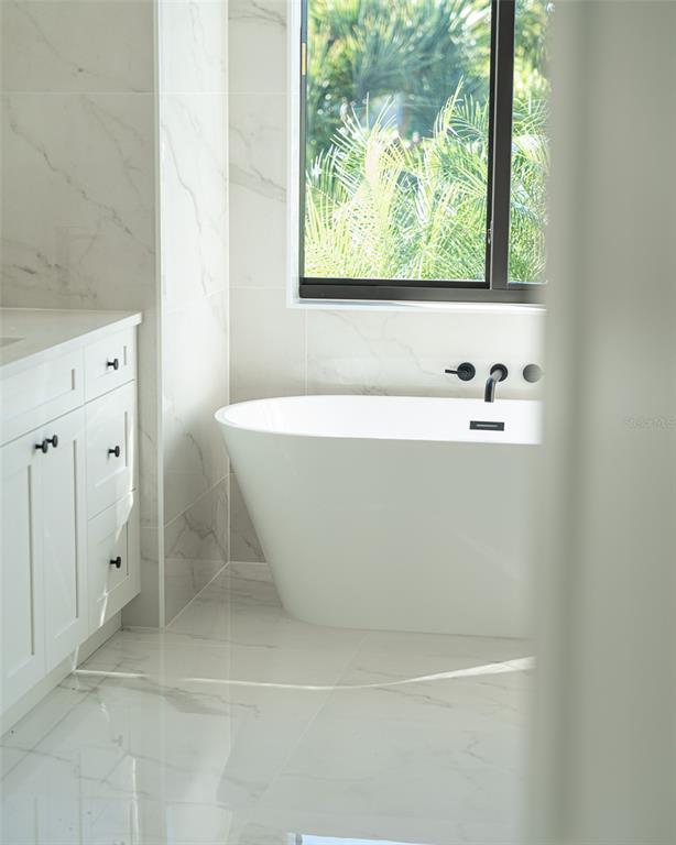 210 Tournament Road Rotonda West, FL 33947 - Photo 22 of 59 a white bath tub sitting next to a window