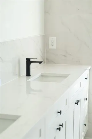 a lamp on a table with a vase of wine sitting on a table