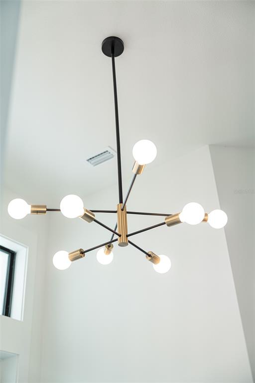 210 Tournament Road Rotonda West, FL 33947 - Photo 25 of 59 a lamp on a table with a vase of wine sitting on a table