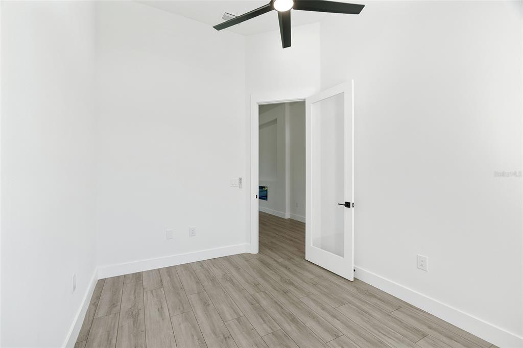 210 Tournament Road Rotonda West, FL 33947 - Photo 27 of 59 a view of an empty room with wooden floor