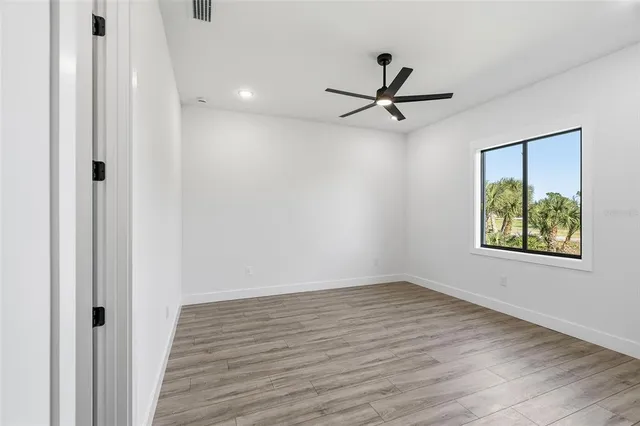 a view of a livingroom with a hardwood floor and a ceiling fan