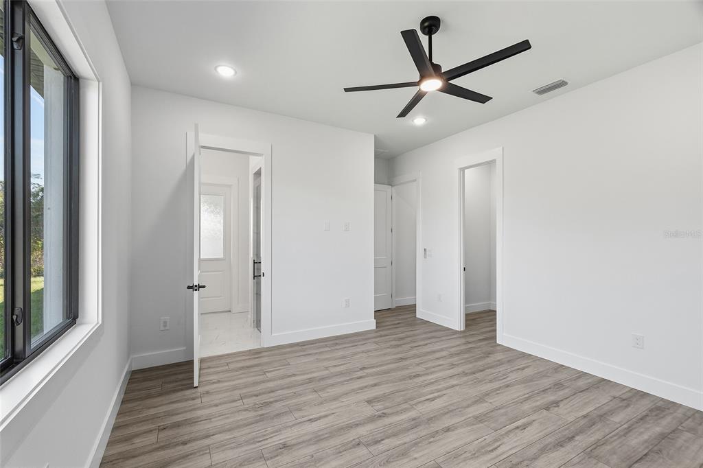 210 Tournament Road Rotonda West, FL 33947 - Photo 29 of 59 a view of a livingroom with a hardwood floor and a ceiling fan
