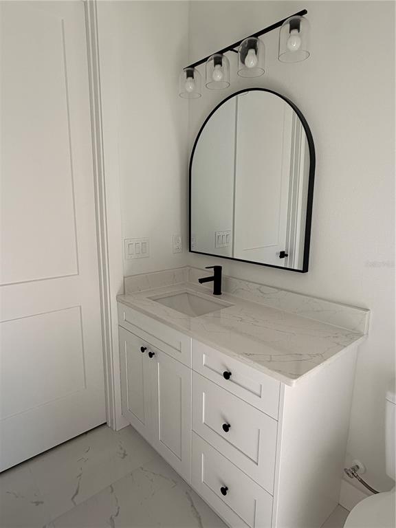 210 Tournament Road Rotonda West, FL 33947 - Photo 33 of 59 a room with a sink and a mirror