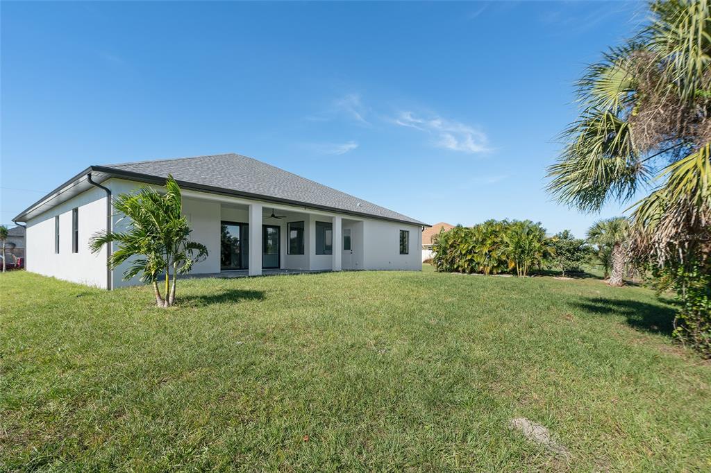 210 Tournament Road Rotonda West, FL 33947 - Photo 47 of 59 a view of a house with a backyard
