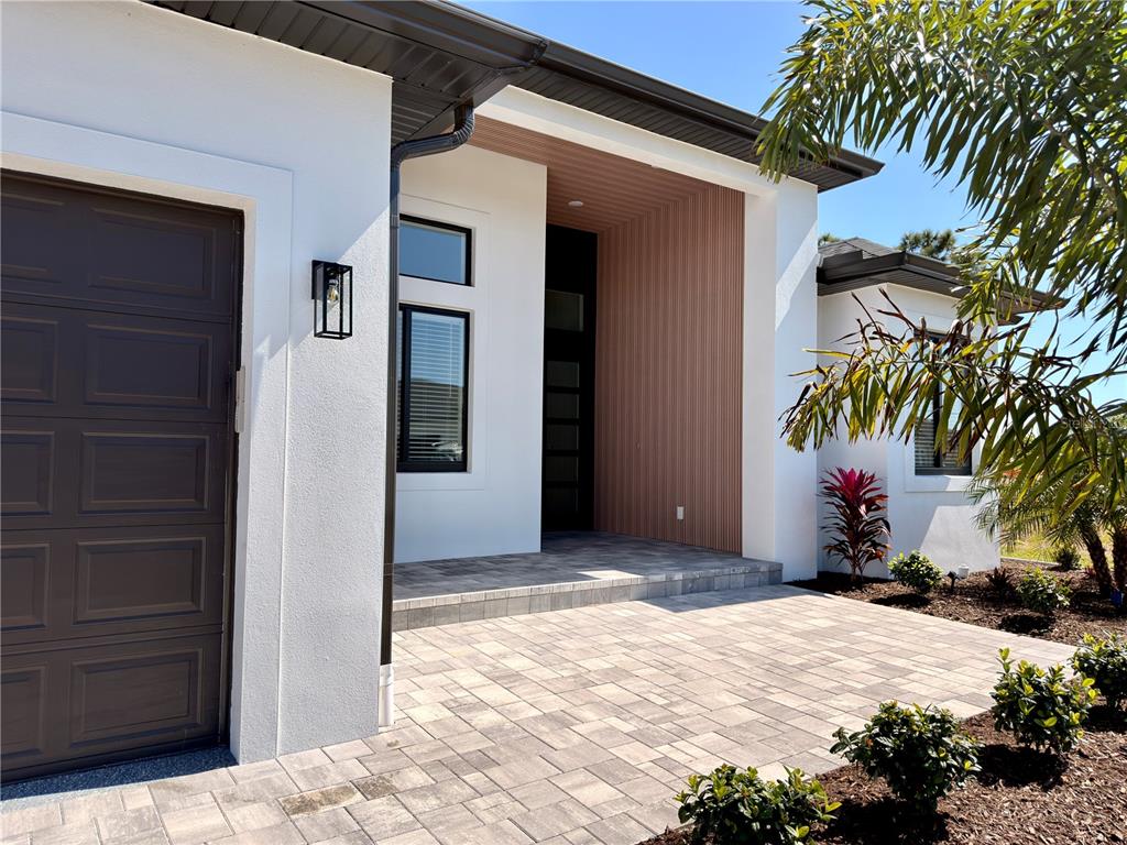 210 Tournament Road Rotonda West, FL 33947 - Photo 49 of 59 a view of a house with a yard