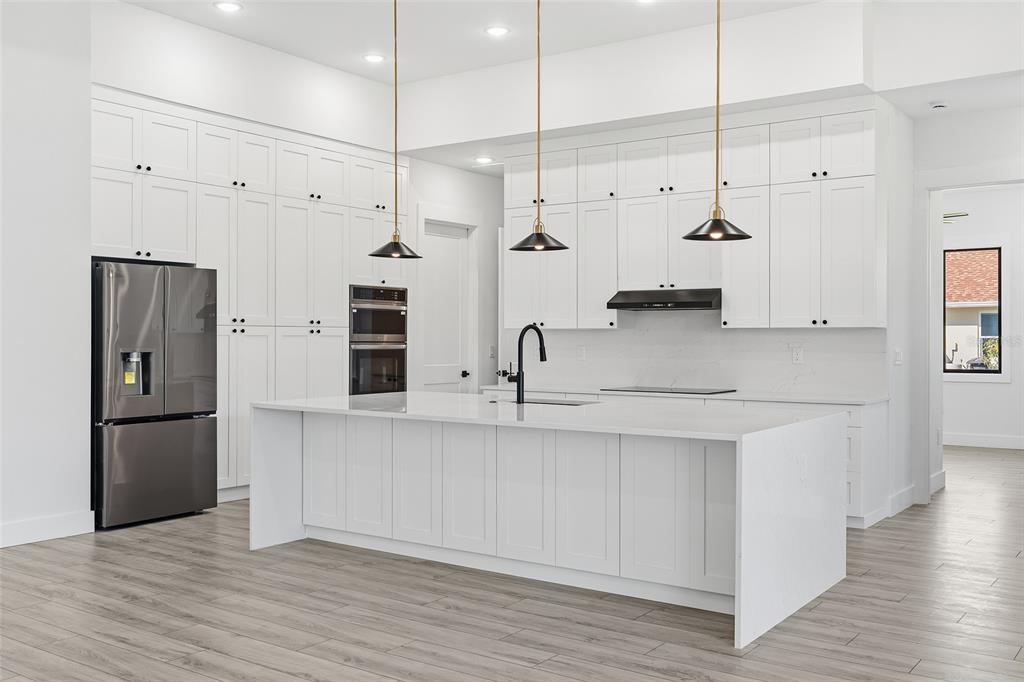 210 Tournament Road Rotonda West, FL 33947 - Photo 5 of 59 a kitchen with stainless steel appliances kitchen island a refrigerator and a sink