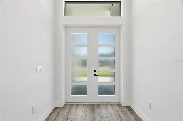 a view of front door with wooden floor