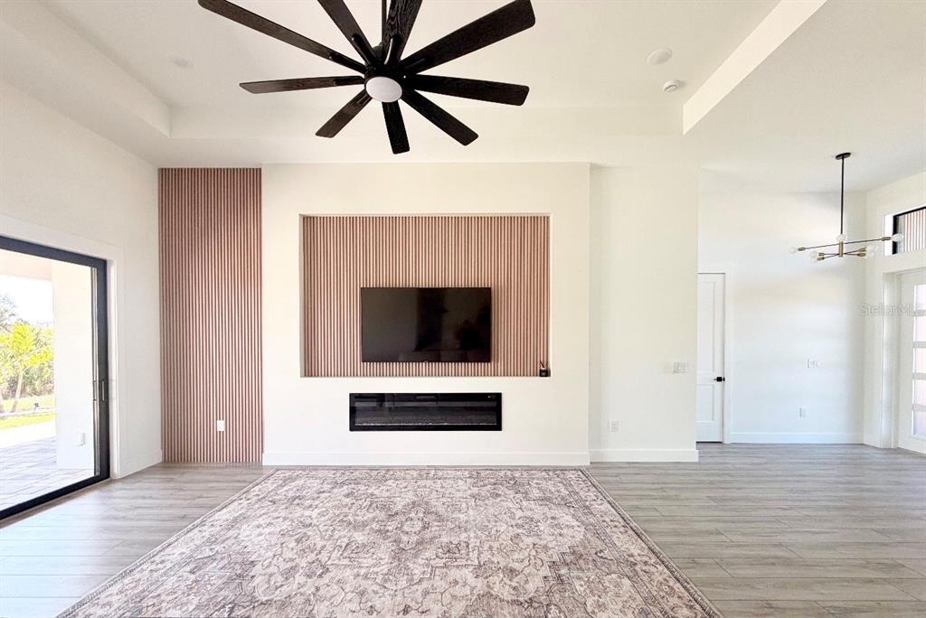 210 Tournament Road Rotonda West, FL 33947 - Photo 7 of 59 a living room with a flat screen tv and a fireplace