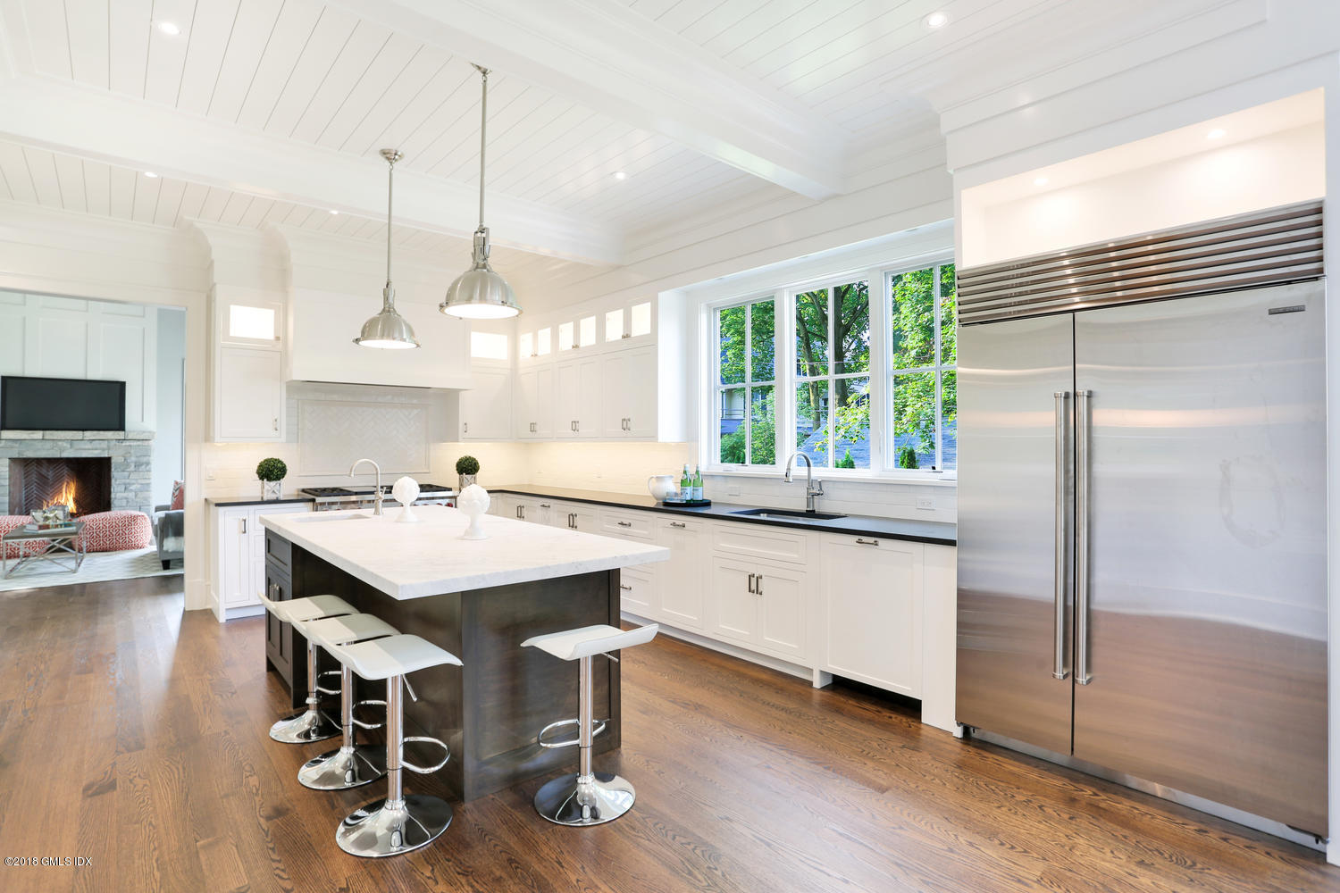 3 Juniper Lane Riverside, CT 06878 - Photo 10 of 30 a kitchen with kitchen island granite countertop a sink a stove a refrigerator and island with wooden floor