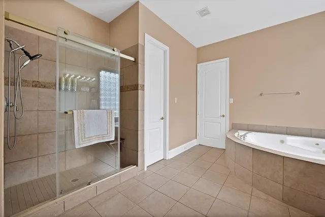 a bathroom with a bathtub and a shower