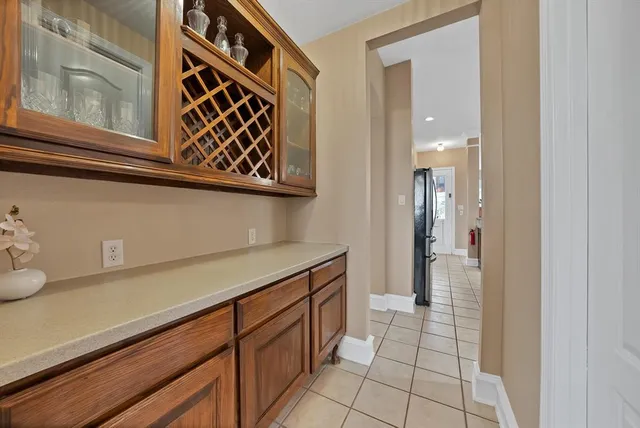 a view of a kitchen with refrigerator and cabinets