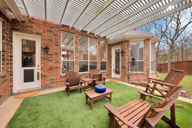 a view of a house with backyard and sitting area