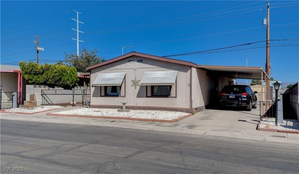 5576 Aldama Road Las Vegas, NV 89122 - Photo 2 of 23 Manufactured / mobile home featuring a carport and driveway