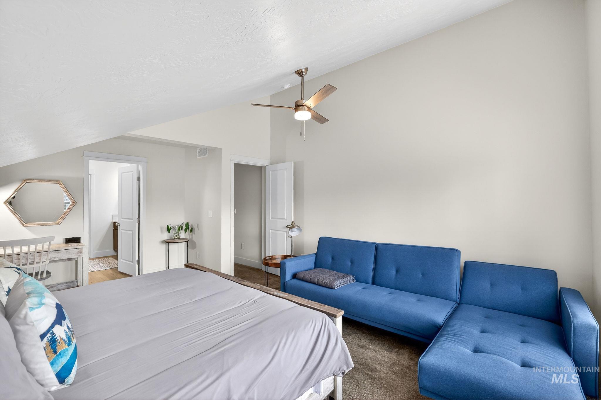 311 Broken Ridge Way McCall, ID 83638 - Photo 23 of 44 Vaulted ceiling bedroom featuring an exposed beam, ceiling fan, and access to an additional room