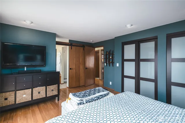 a view of a balcony with wooden floor next to a yard