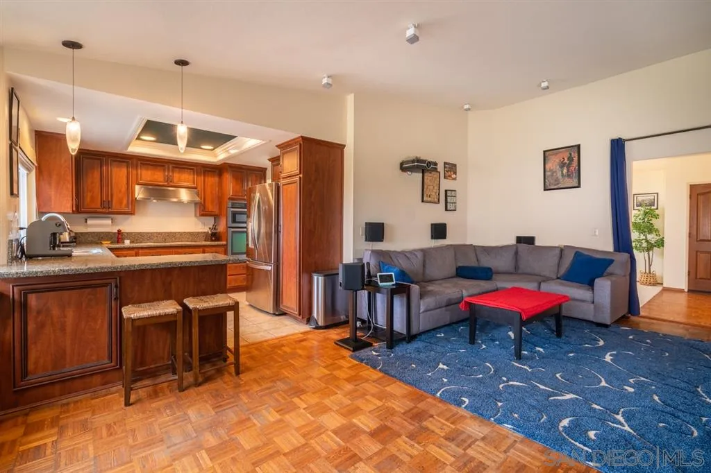 2039 Wandering Road Encinitas, CA 92024 - Photo 8 of 25 a living room with furniture a flat screen tv and kitchen view