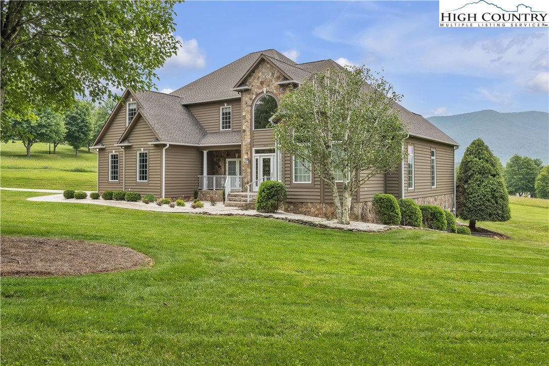 891 Olde Charter Circle Jefferson, NC 28640 - Photo 1 of 49 a front view of a house with a garden