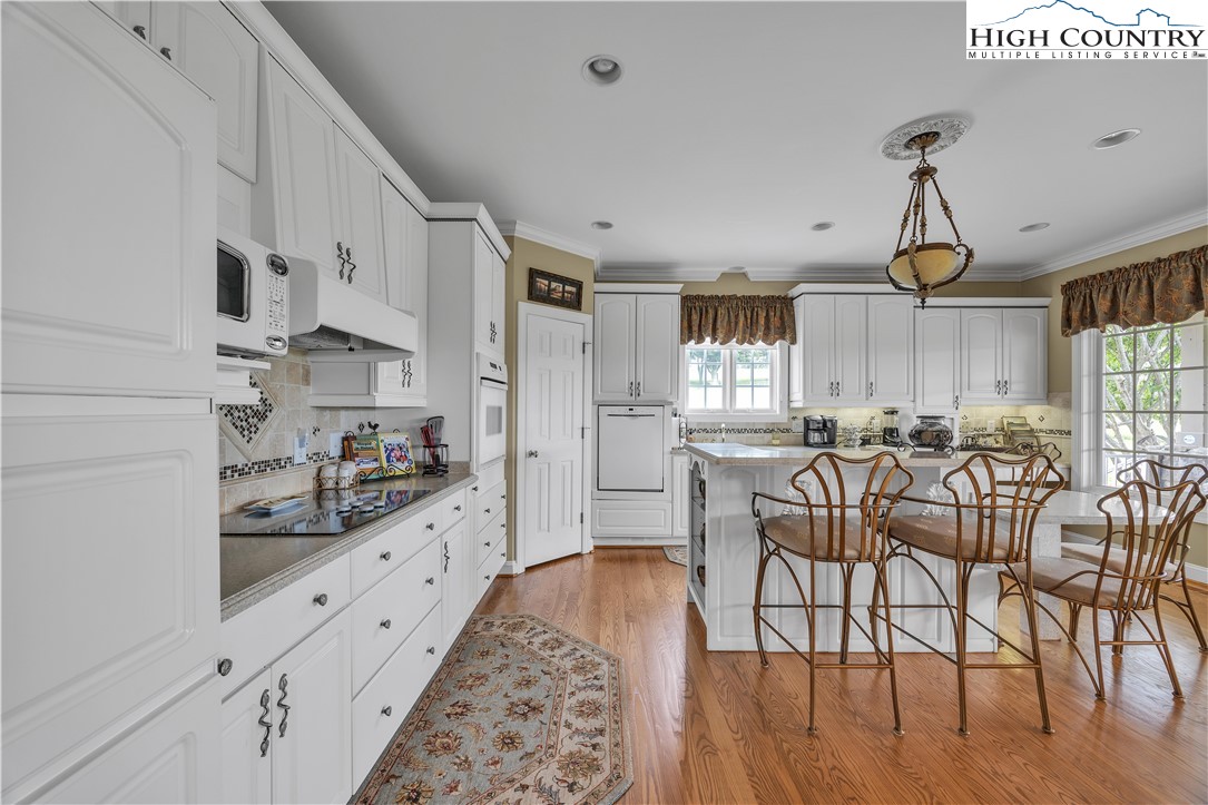 891 Olde Charter Circle Jefferson, NC 28640 - Photo 12 of 49 a kitchen with granite countertop white cabinets and window