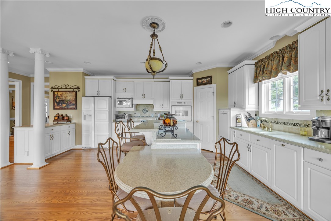 891 Olde Charter Circle Jefferson, NC 28640 - Photo 13 of 49 a dining room with furniture a chandelier and wooden floor
