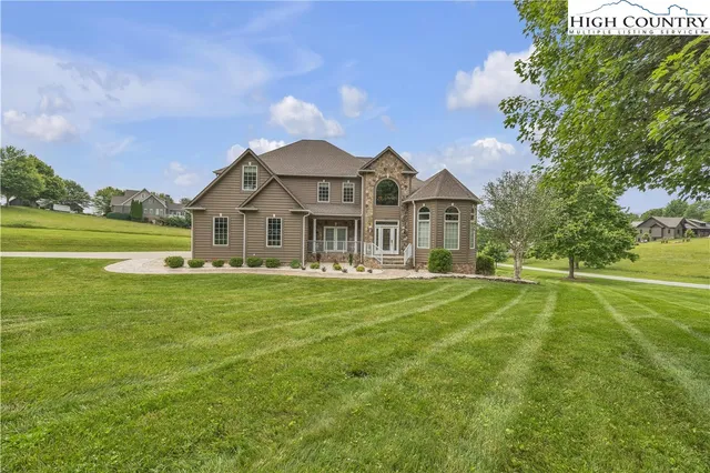 a view of a big house with a big yard and potted plants