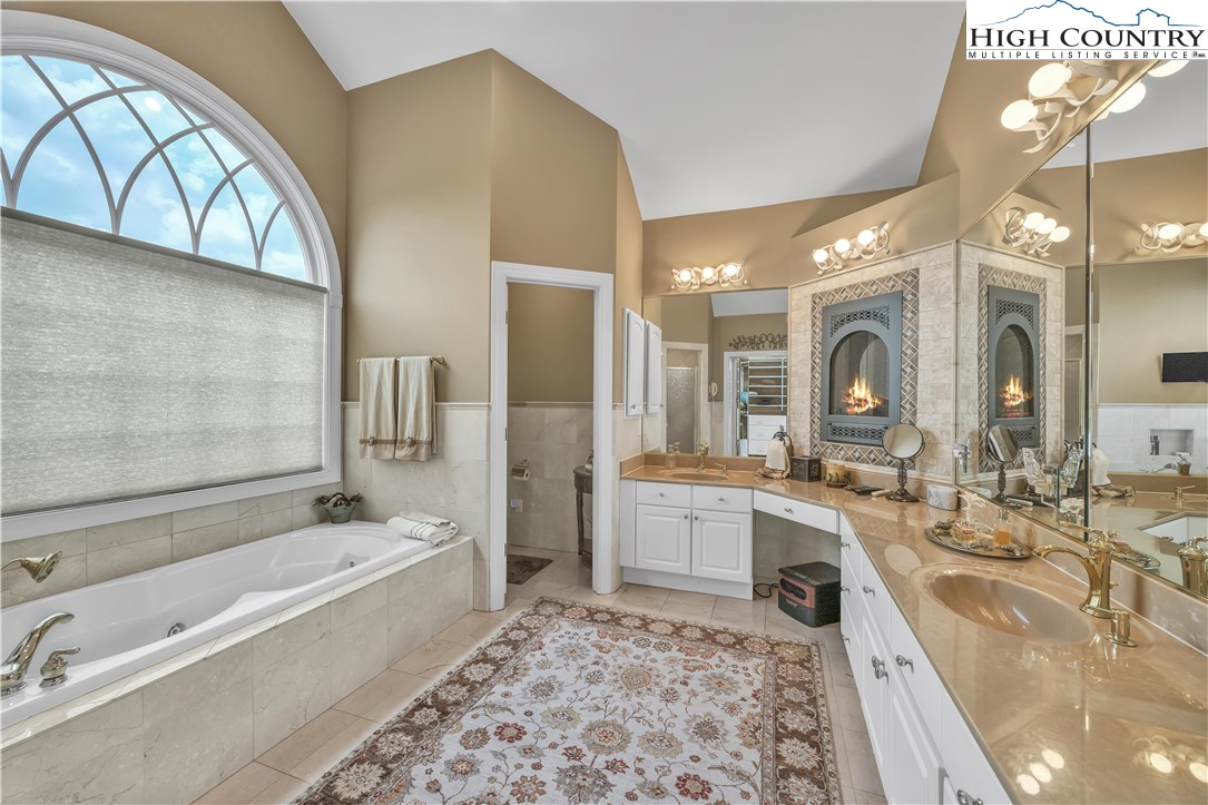 891 Olde Charter Circle Jefferson, NC 28640 - Photo 21 of 49 a bathroom with a large tub sink and double vanity