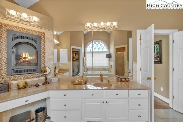 a large bathroom with double vanity and a mirror