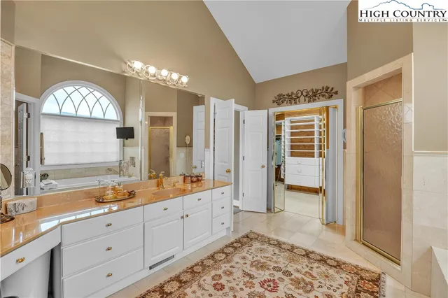 a spacious bathroom with double sink and a mirror