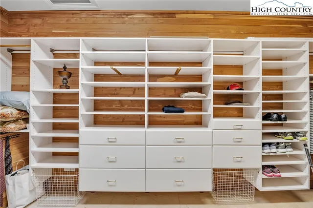a view of walk in closet with empty racks
