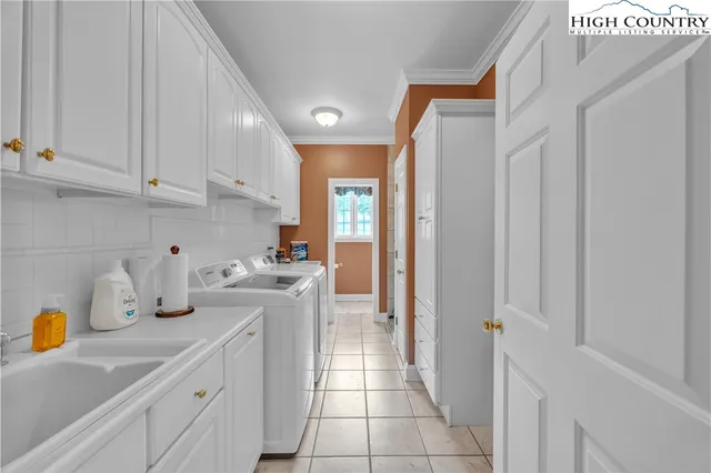 a kitchen with a sink dishwasher stove and cabinets