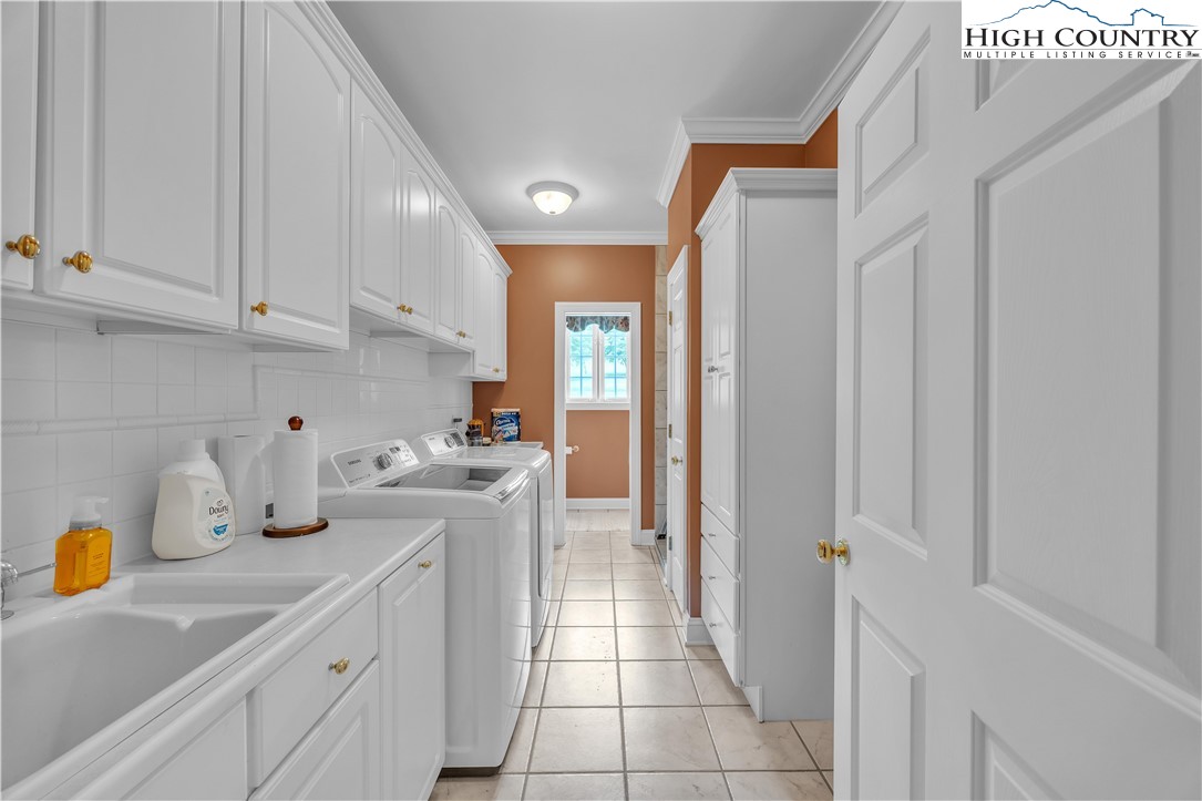 891 Olde Charter Circle Jefferson, NC 28640 - Photo 28 of 49 a kitchen with a sink dishwasher stove and cabinets