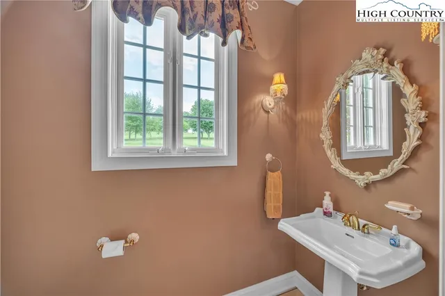 a bathroom with a sink a mirror and a window