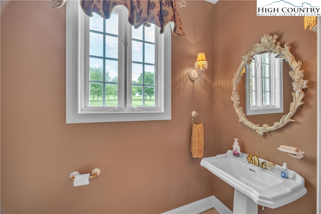 891 Olde Charter Circle Jefferson, NC 28640 - Photo 29 of 49 a bathroom with a sink a mirror and a window