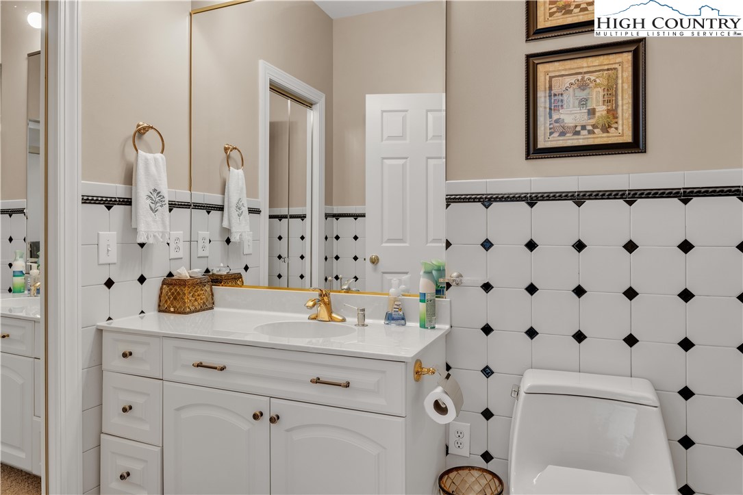 891 Olde Charter Circle Jefferson, NC 28640 - Photo 32 of 49 a bathroom with a sink a toilet and a mirror