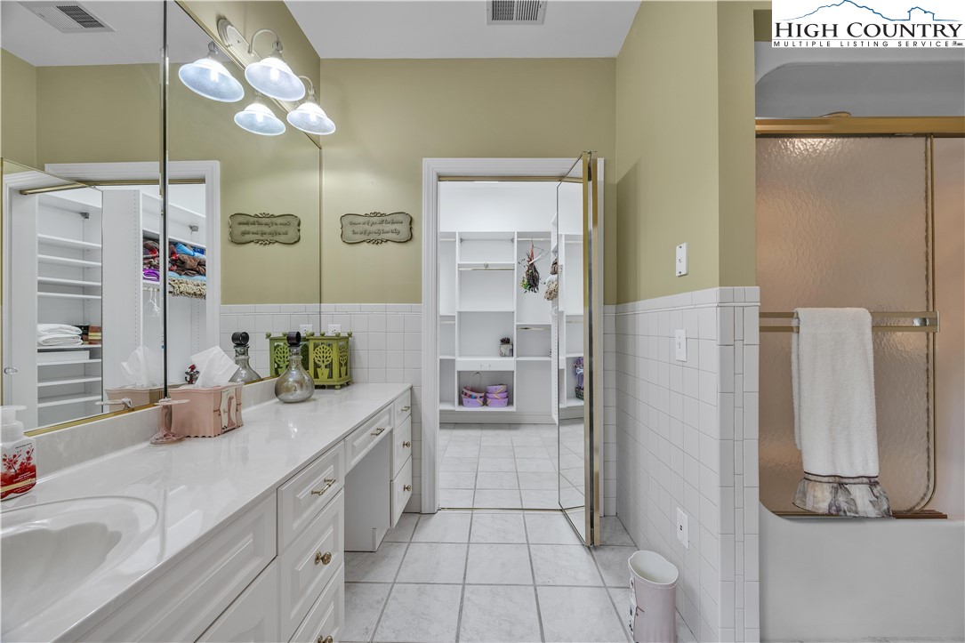 891 Olde Charter Circle Jefferson, NC 28640 - Photo 35 of 49 a spacious bathroom with a granite countertop sink mirror and a shower