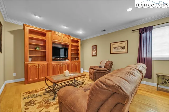 a bedroom with furniture and a flat screen tv