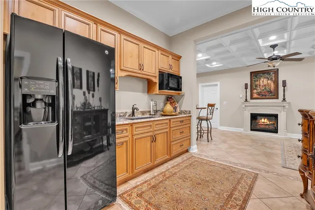 a large kitchen with cabinets and a fireplace