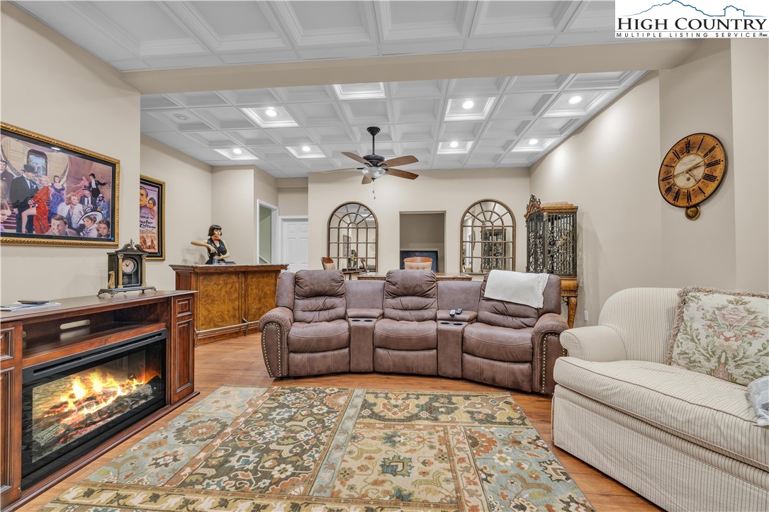 891 Olde Charter Circle Jefferson, NC 28640 - Photo 41 of 49 a living room with furniture a fireplace and a flat screen tv