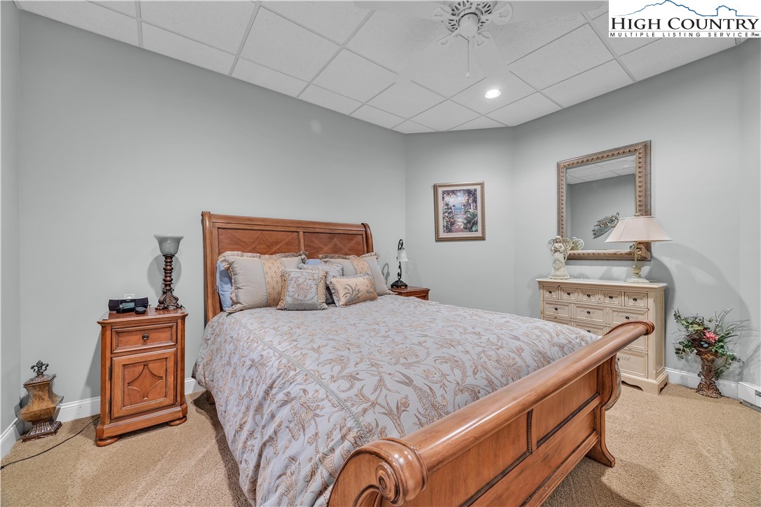 891 Olde Charter Circle Jefferson, NC 28640 - Photo 44 of 49 a bedroom with a bed and a dresser in it