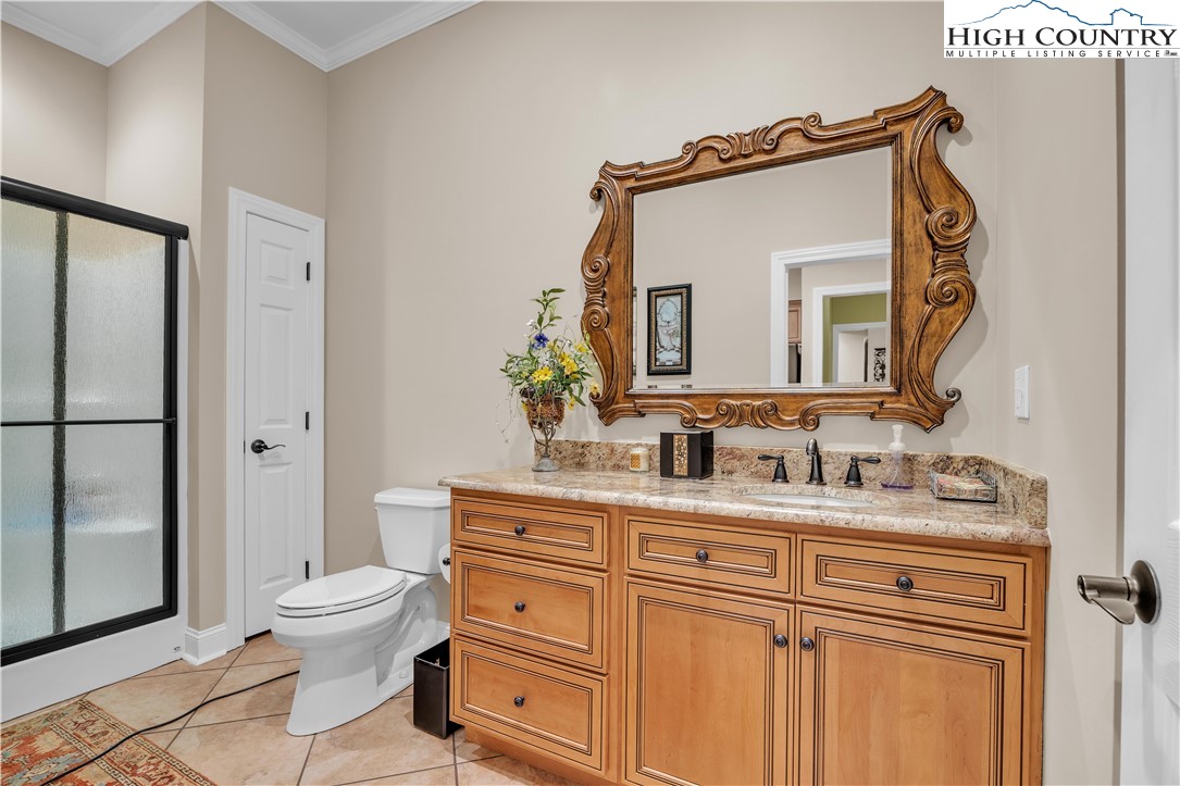 891 Olde Charter Circle Jefferson, NC 28640 - Photo 45 of 49 a bathroom with a toilet a sink and a mirror