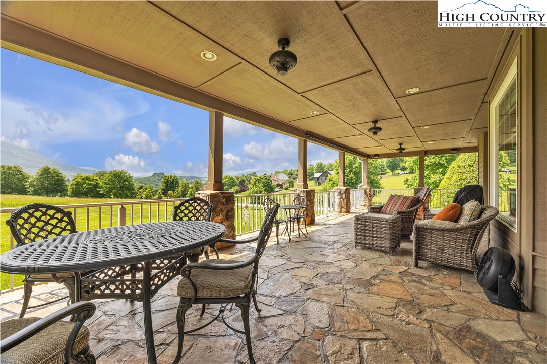 891 Olde Charter Circle Jefferson, NC 28640 - Photo 48 of 49 a view of a patio with a dining table and chairs