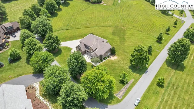 an aerial view of a residential apartment building with a yard