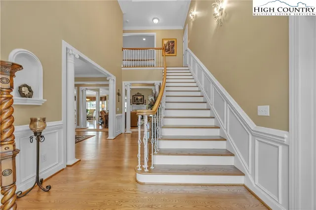 a view of entryway and hall with wooden floor