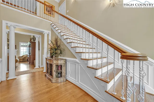 a view of entryway and hall with wooden floor