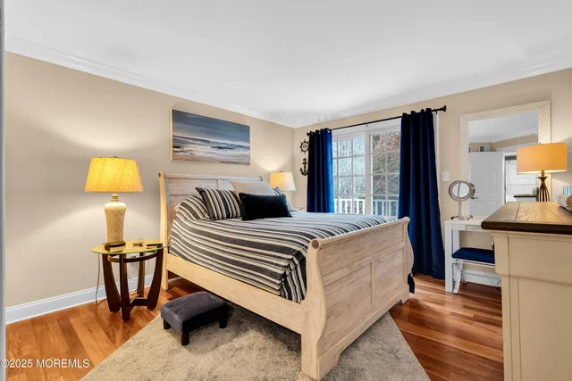 a bedroom with a bed and a lamp with the wooden floor