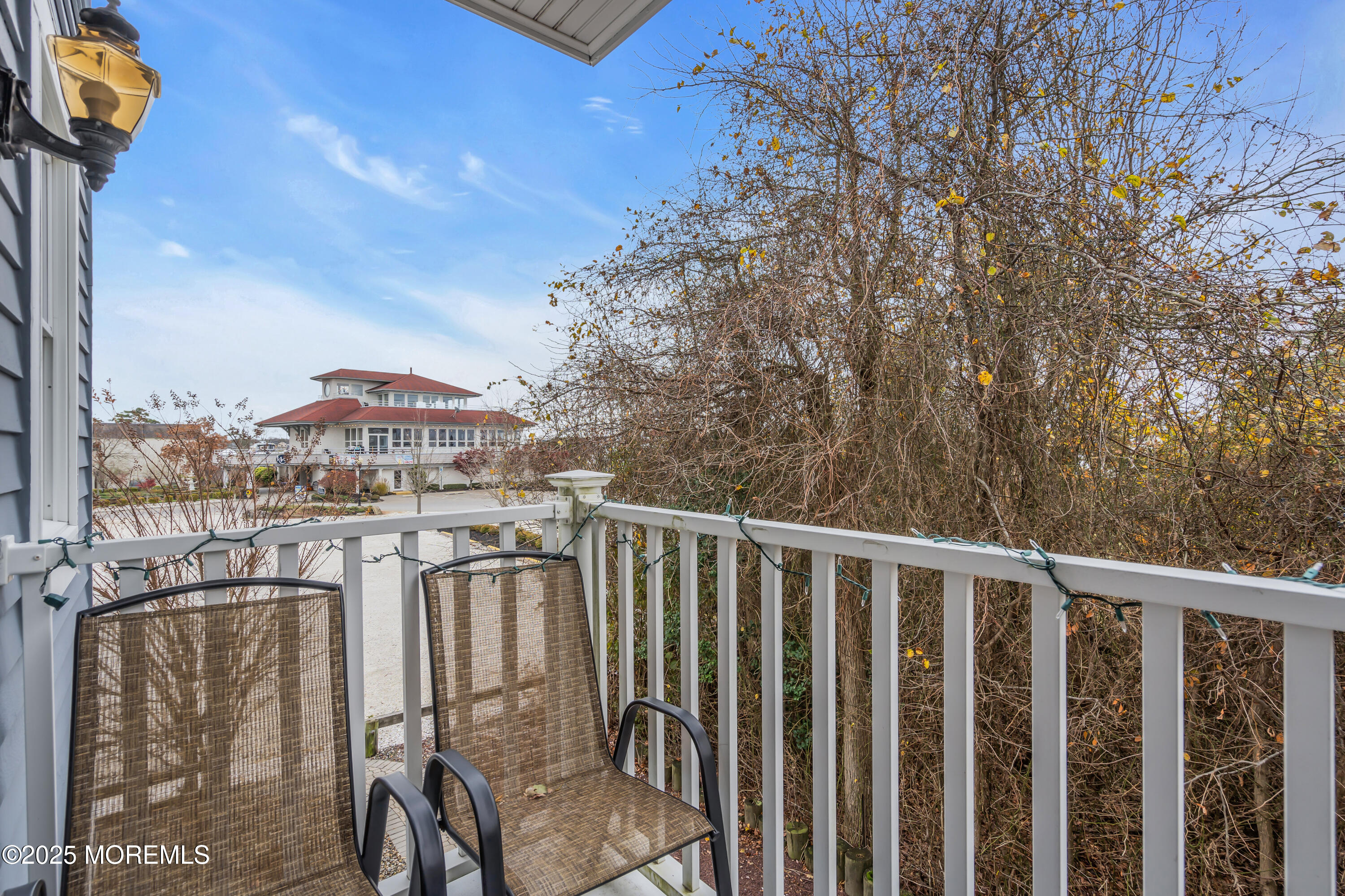 336 Lacey Road, Unit 36 Forked River, NJ 08731 - Photo 21 of 44 a balcony with table and chairs