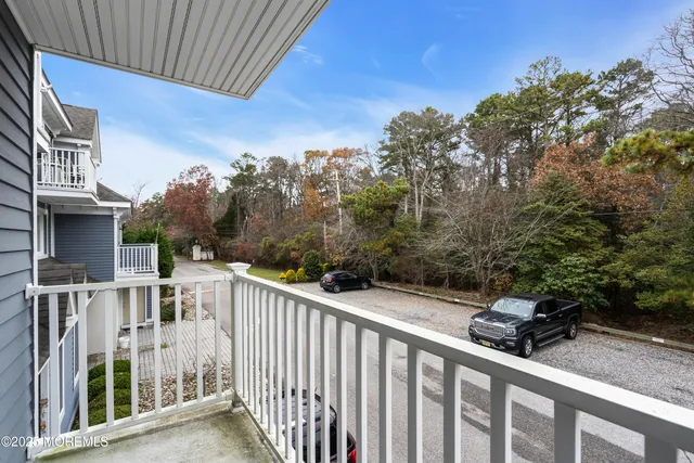 a view of a house with backyard and trees